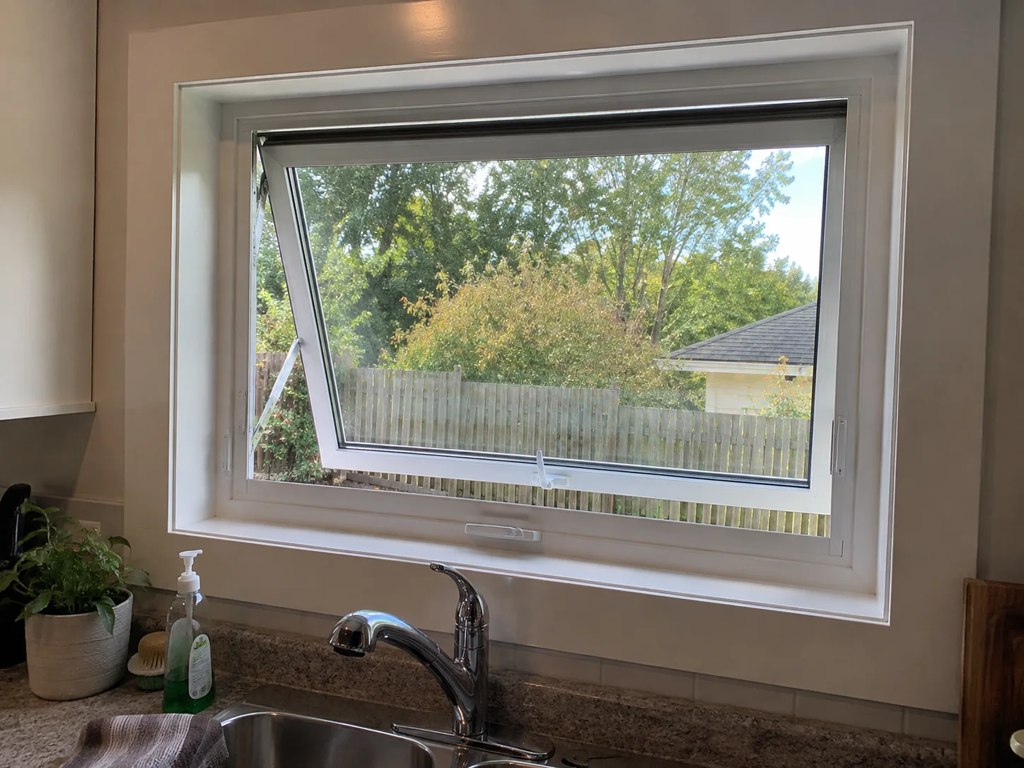 Top-hinged awning window above a kitchen sink